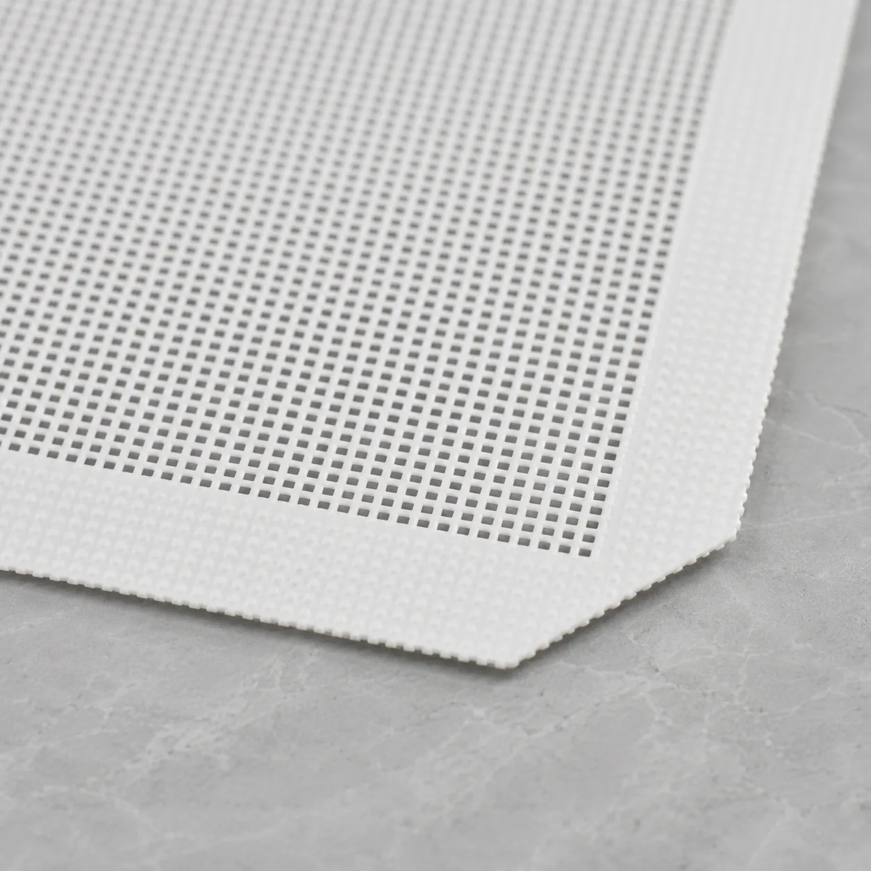 Close-up of silicone-coated fiberglass mesh and its reinforced border