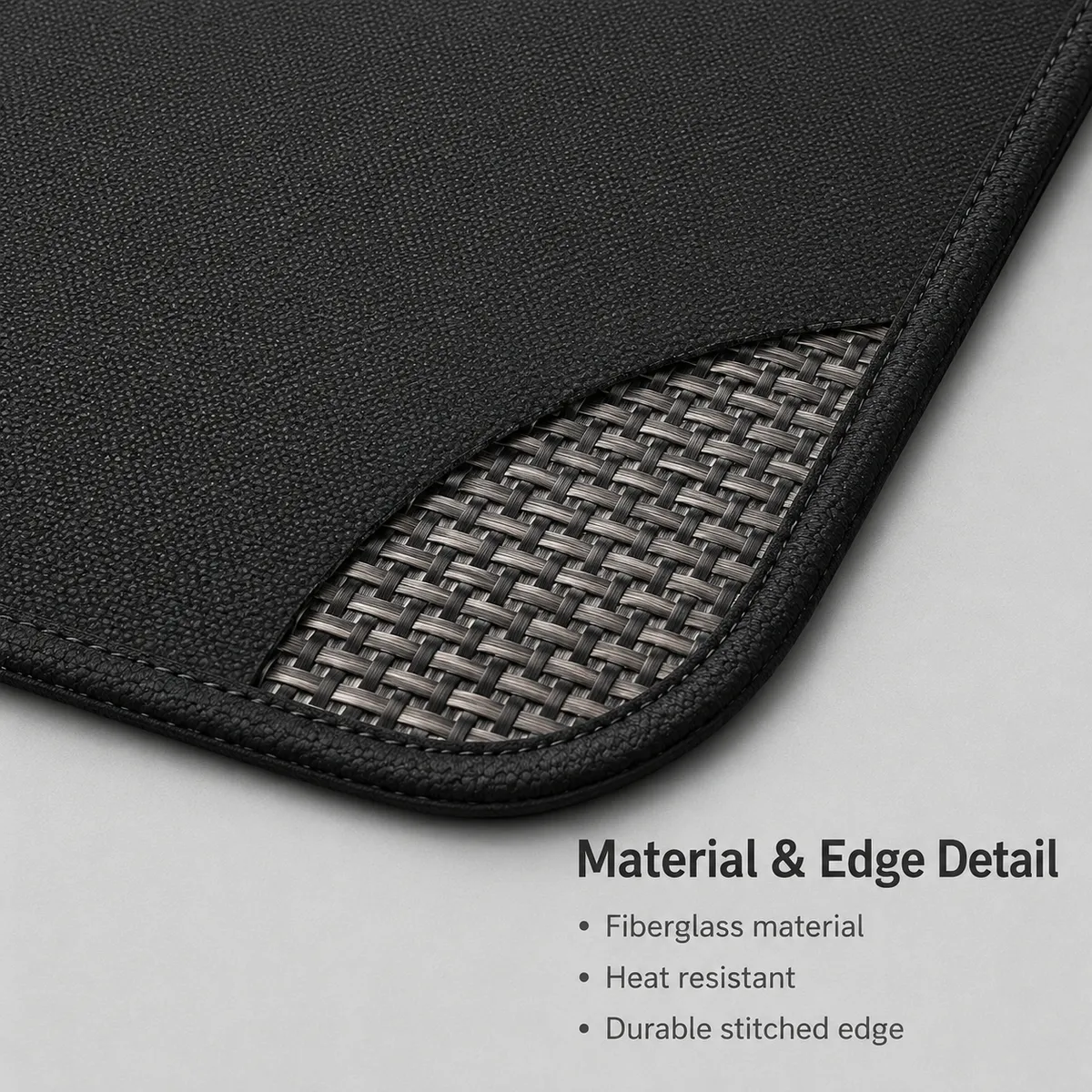 Close-up of black fiberglass grill mat material and stitched edge